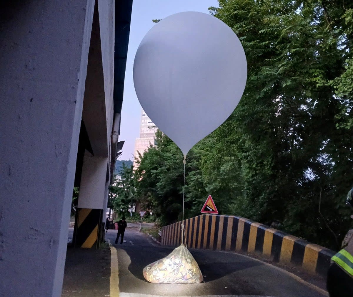 A balloon believed to have been sent by North Korea, carrying various objects including what appeared to be rubbish (via REUTERS)