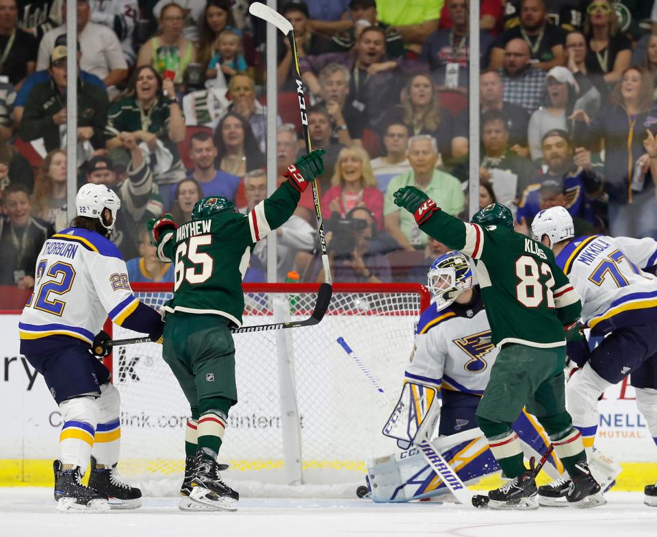 Minnesota Wild right wing Gerald Mayhew (65) celebrates a goal by Minnesota Wild center Justin Kloos (82) on St. Louis Blues goaltender Ville Husso during the first period of an NHL preseason hockey game, Wednesday, Sept. 19, 2018, in Des Moines, Iowa.