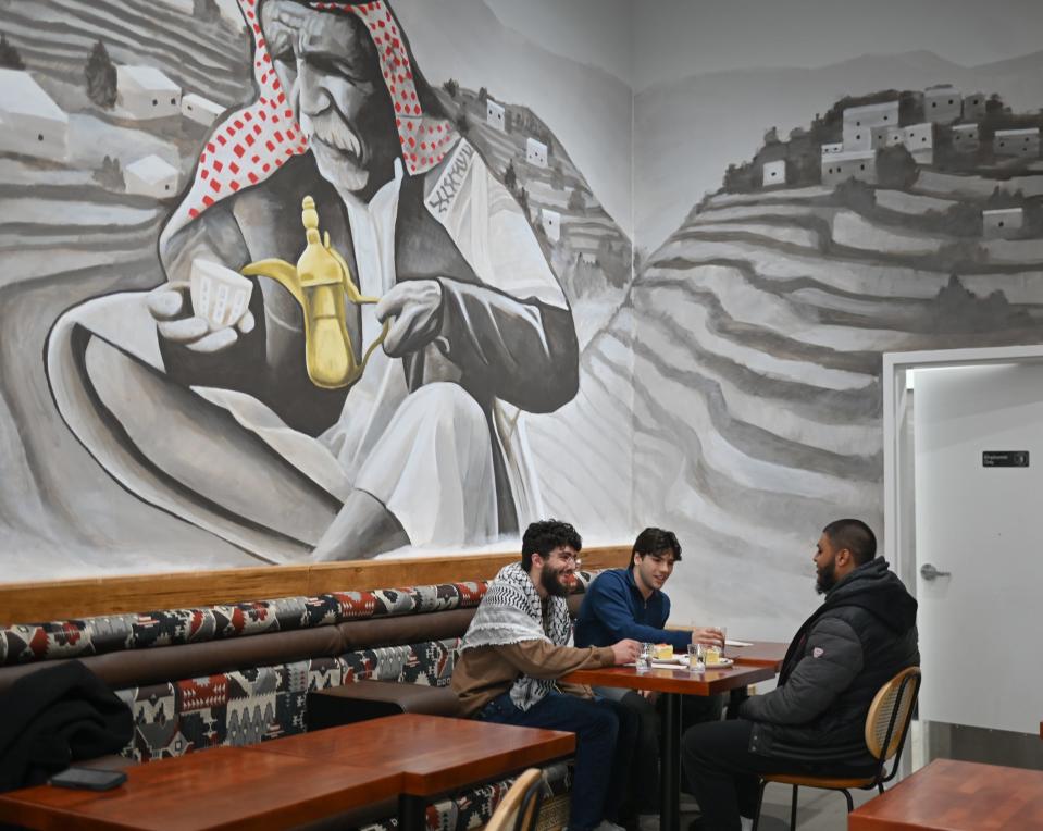 Patrons share coffee and desserts Friday, Jan. 5, 2024, at Moka & Co., a new East Lansing cafe that features traditional Yemeni coffees, teas and desserts.