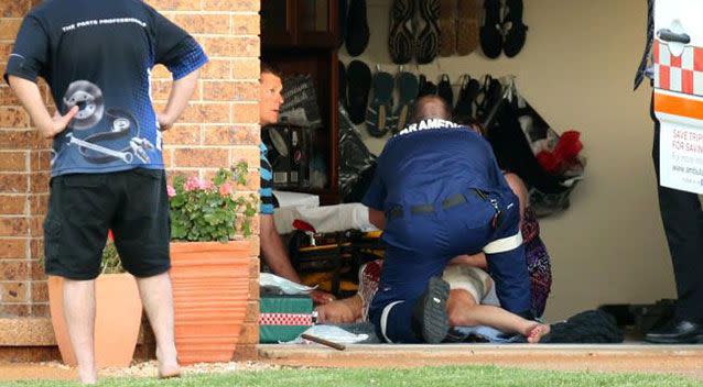 Paramedics treat the  28-year-old woman at Port Macquarie. Photo: Nathan Edwards/Daily Telegraph