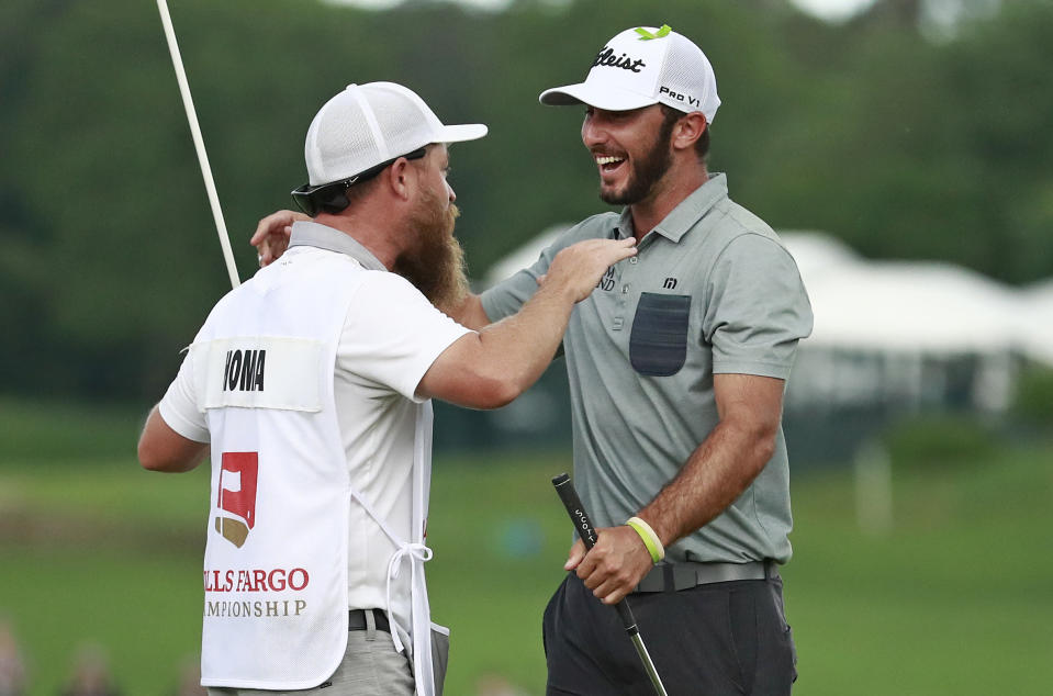 Max Homa, right, celebrates with his caddie after winning the Wells Fargo Championship golf tournament at Quail Hollow Club in Charlotte, N.C., Sunday, May 5, 2019. (AP Photo/Jason E. Miczek)