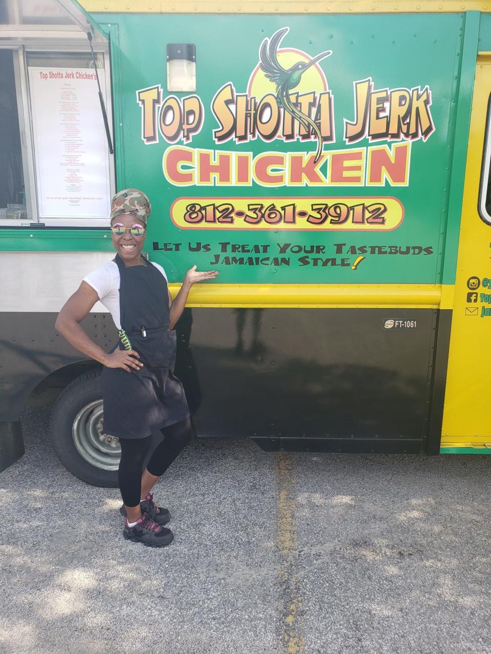 Taneisha Henline stands outside her Top Shotta Jerk Chicken food truck.