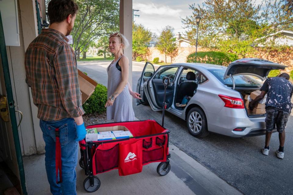 In this file photo, a social worker hands out harm reduction materials to help with substance use disorder on May 12, 2022. Interventions such as harm reduction are meant to combat the rising number of overdose deaths in the U.S.