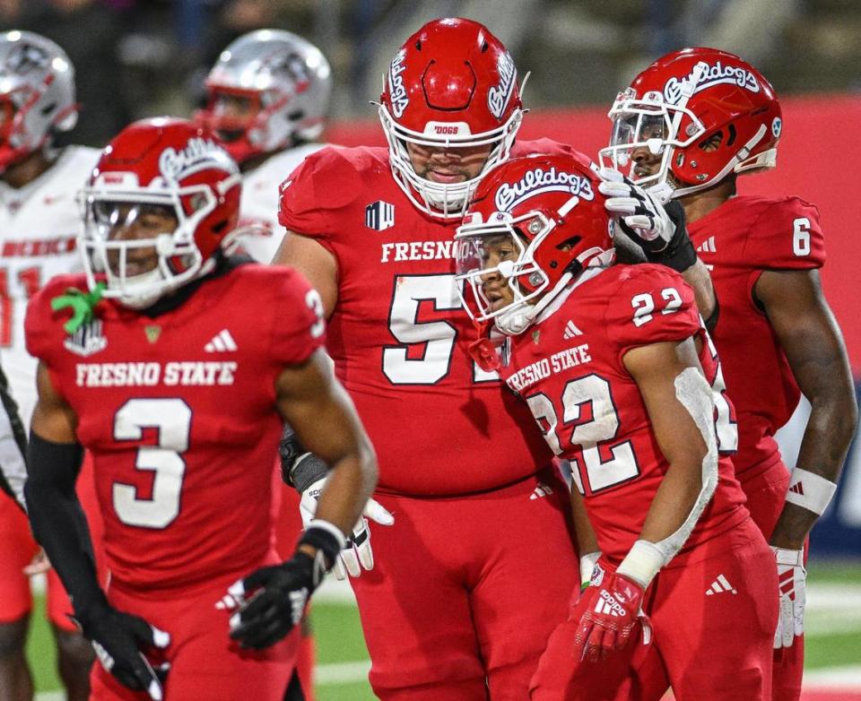 Fresno State’s Malik Sherrod, center right in No 22, is congratulated by teammates after scoring a touchdown against New Mexico n their game at Valley Children’s Stadium on Saturday, Nov. 18, 2023.