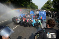 <p>Police uses a water canon while demonstrators block a street during protests against the G-20 summit in Hamburg, Germany, Friday, July 7, 2017. (Daniel Reinhardt/dpa via AP) </p>