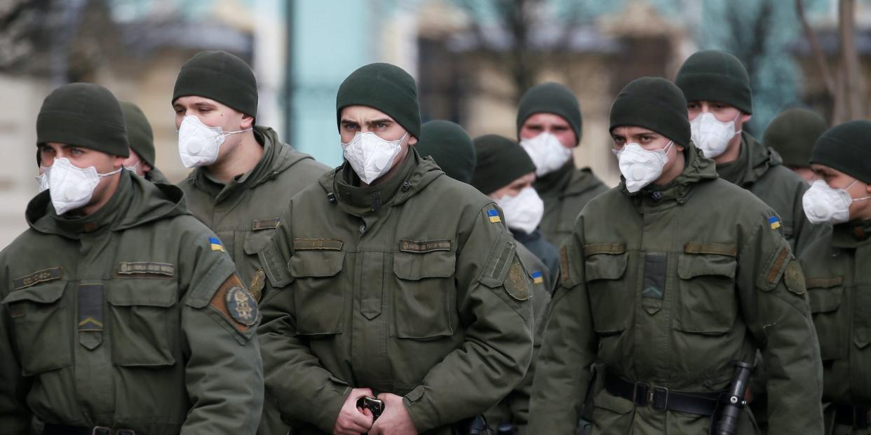 Members of Ukraine's national guard wearing uniforms and masks