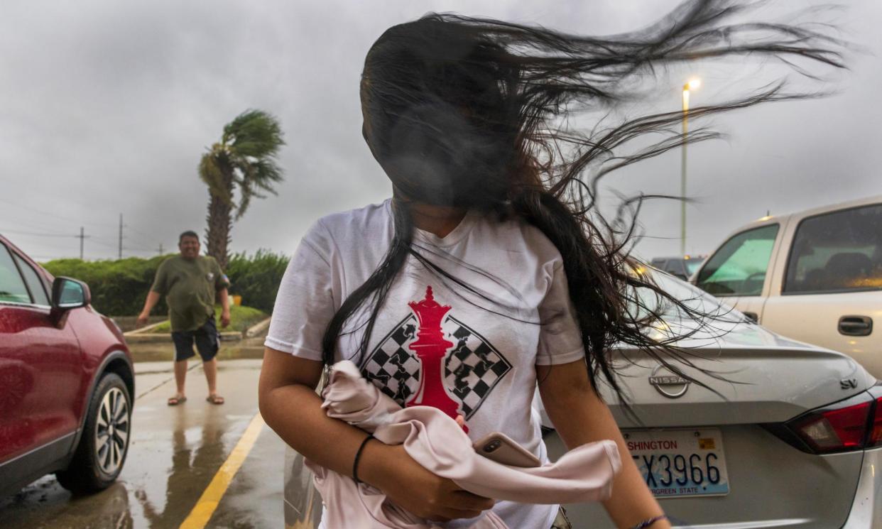 <span>Melanie Galindo's hair flies in the swirl of fast-moving air as the eyewall of Hurricane Francine crosses into the Houma area in Louisiana on Wednesday.</span><span>Photograph: Chris Granger/AP</span>