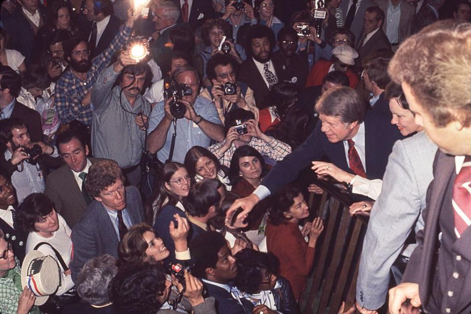 <p>After his win against incumbent President Gerald Ford, Jimmy Carter and his wife Rosalynn Carter were photographed greeting fans on the way to the inaugural ball in 1977. </p>