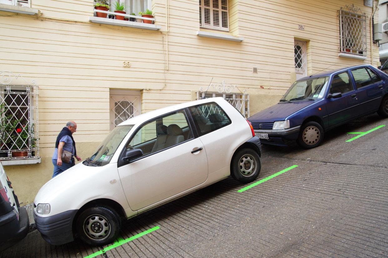 Barcelona, Spain - June 10, 2011: Uphill street with parking lot on a slant in Barcelona