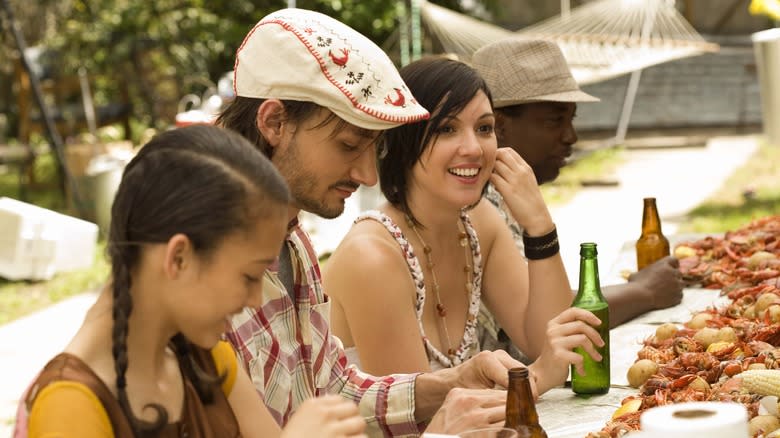 people sitting at crawfish table