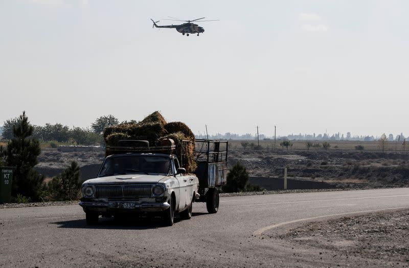 An Azerbaijani military helicopter flies during the fighting over the breakaway region of Nagorno-Karabakh near the city of Terter