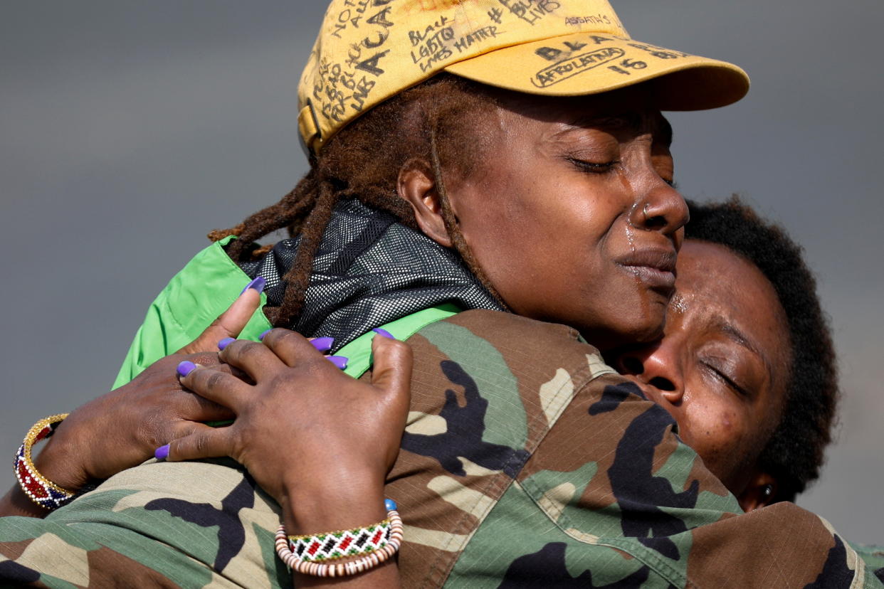 Phoenix Robles and Dorcas Monari hug each other near the Brooklyn Center Police Department in Minnesota after Robles, who was passing by, stopped to protect Monari, who was protesting in the street. (Nick Pfosi/Reuters)