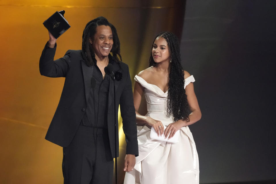 Jay-Z, left, accepts the Dr. Dre Global Impact Award as daughter Blue Ivy Carter, looks on during the 66th annual Grammy Awards on Sunday, Feb. 4, 2024, in Los Angeles. (AP Photo/Chris Pizzello)