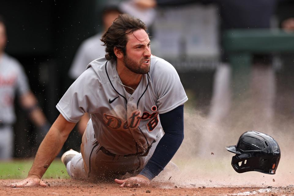 Matt Vierling of the Detroit Tigers celebrates as he slides safely into home plate for a run against the Baltimore Orioles during the eighth inning at Oriole Park at Camden Yards on April 23, 2023