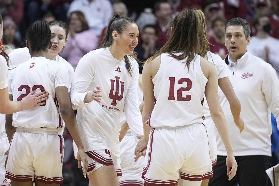 Indiana's Mackenzie Holmes, middle, greets Yarden Garzon (12) during a timeout in the second half of a first-round college basketball game against Tennessee Tech in the women's NCAA Tournament Saturday, March 18, 2023, in Bloomington, Ind. (AP Photo/Darron Cummings)