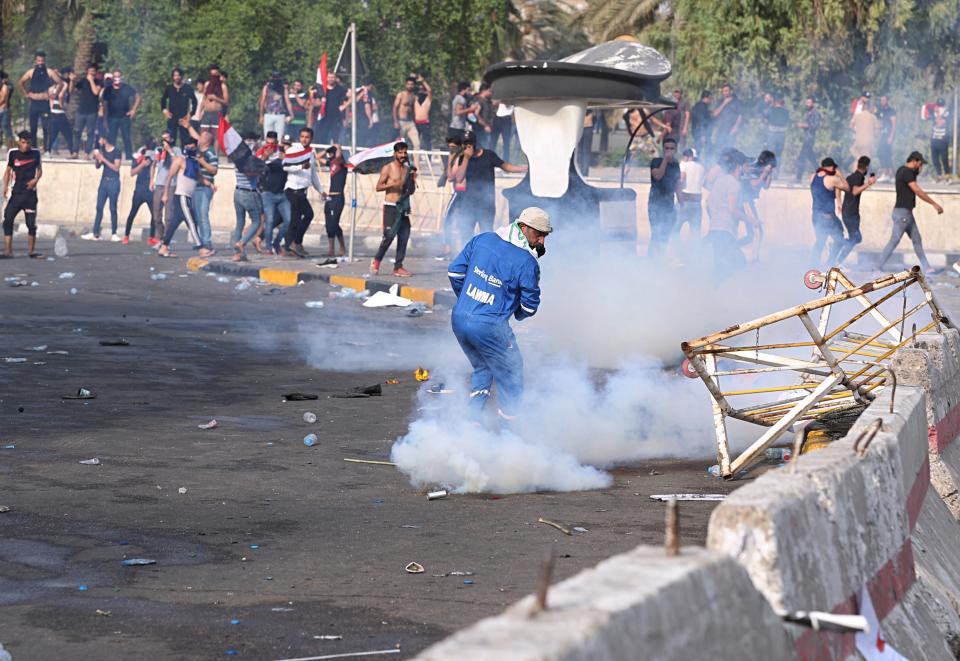 Iraqi security forces fire tear gas during a protest in Tahrir Square, in central Baghdad, Iraq, Tuesday, Oct. 1, 2019. Iraqi security forces fired tear gas on hundreds of protesters in the Iraqi capital who were demonstrating against corruption and bad public services. (AP Photo/Khalid Mohammed)