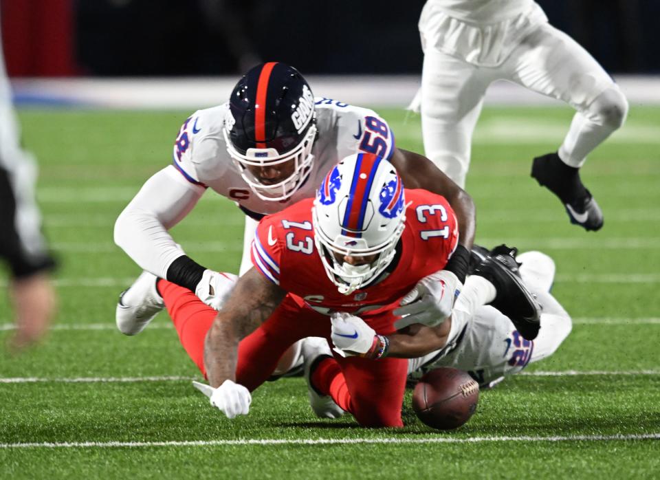 Bills wide receiver Gabe Davis fumbles the ball on a tackle by Giants linebacker Bobby Okereke.