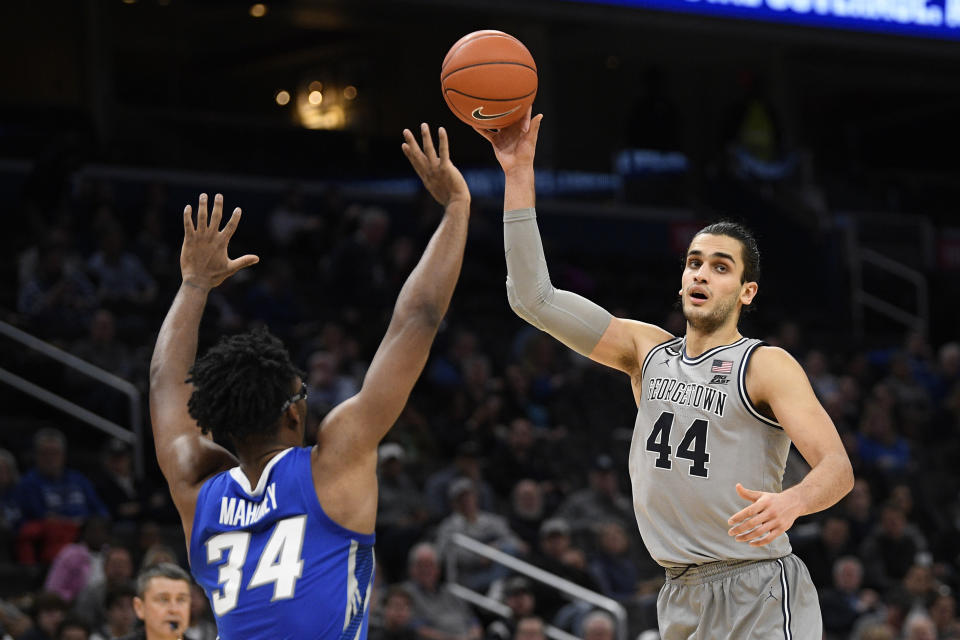 Georgetown center Omer Yurtseven (44) handles the ball next to Creighton guard Denzel Mahoney (34) during the second half of an NCAA college basketball game, Wednesday, Jan. 15, 2020, in Washington. Georgetown won 83-80. (AP Photo/Nick Wass)