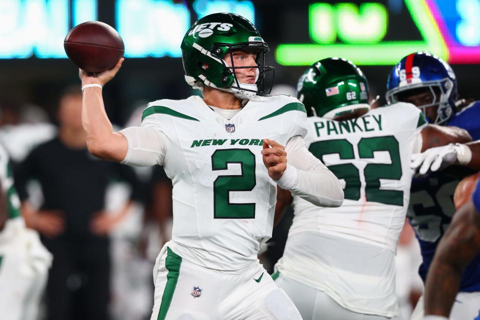 In relief of injured starter Aaron Rodgers, Zach Wilson completed 14-of-21 passes for 140 yards and a touchdown on Monday night in the New York Jets' overtime win over the Buffalo Bills.