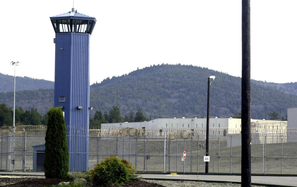 FILE - A tower stands at Pelican Bay State Prison outside of Crescent City, Calif. The Northern California prison was on generator power for a second week and inmates were issued masks to cope with unhealthy air after wildfires knocked out electricity and choked the remote region with smoke. (AP Photo/Rich Pedroncelli, File)