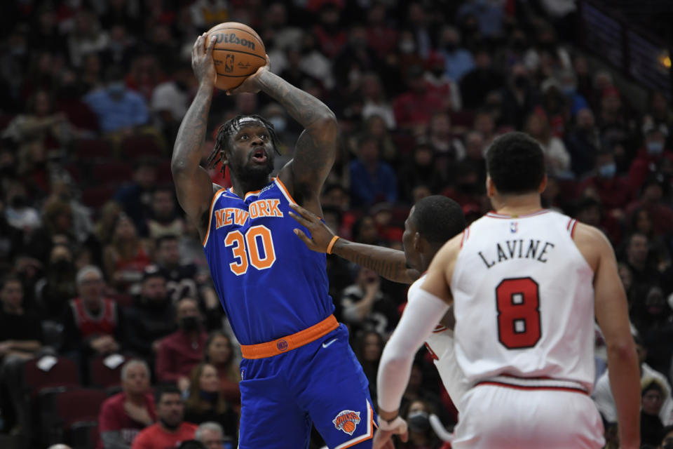 New York Knicks' Julius Randle (30) goes up for a shot against Chicago Bulls' Javonte Green (24) and Zach LaVine (8) during the first half of a NBA basketball game Sunday, Nov. 21, 2021 in Chicago. (AP Photo/Paul Beaty)