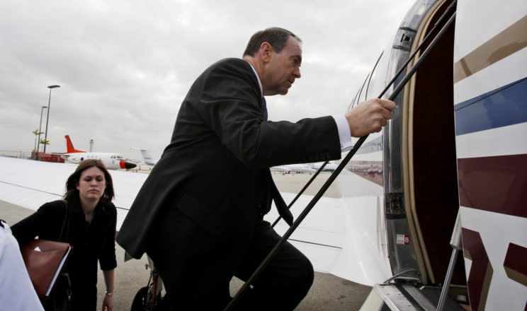 Republican presidential hopeful former Arkansas Gov. Mike Huckabee gets on his charter plane in Miami, Friday, Jan. 25, 2008, as he campaigns across Florida. At left is his daughter Sarah Huckabee. (AP Photo/Charles Dharapak)