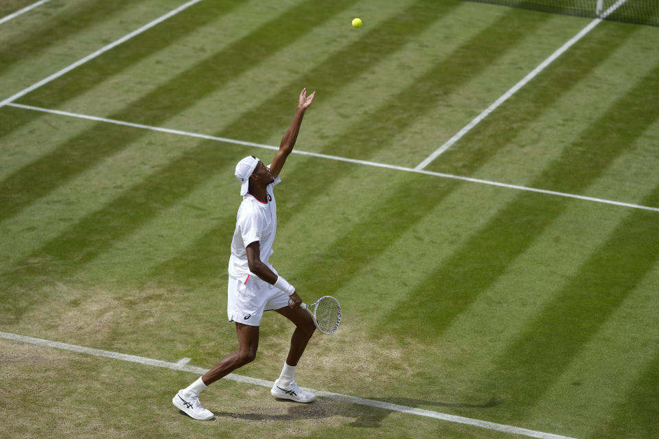 Christopher Eubanks of the US serves to Stefanos Tsitsipas of Greece in a men's singles match on day eight of the Wimbledon tennis championships in London, Monday, July 10, 2023. (AP Photo/Alastair Grant)