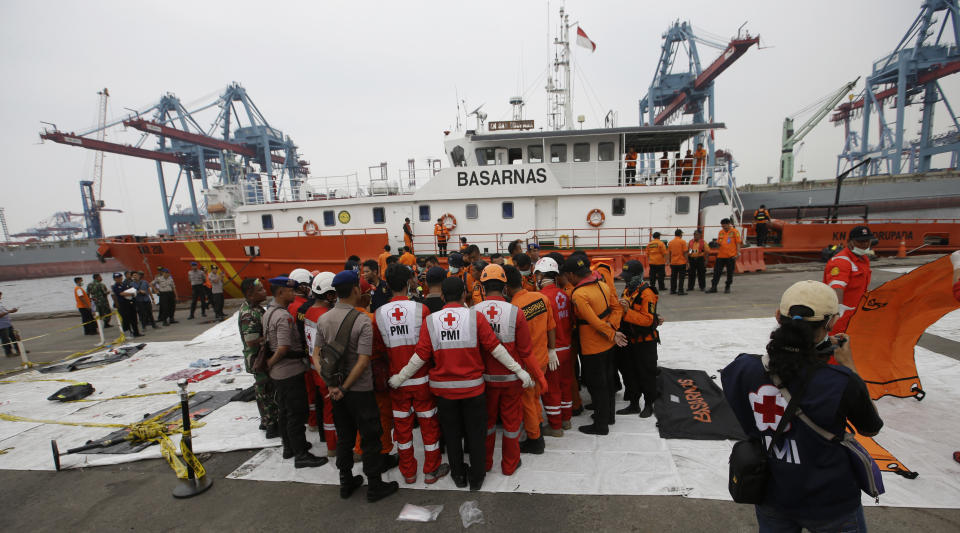 Rescuers examine victims recovered the Lion Air jet that crashed into Java Sea on Monday at Tanjung Priok Port in Jakarta, Indonesia, Saturday, Nov. 3, 2018. New details about the crashed aircraft previous flight have cast more doubt on the Indonesian airline's claim to have fixed technical problems as hundreds of personnel searched the sea a fifth day Friday for victims and the plane's fuselage. (AP Photo/Achmad Ibrahim)