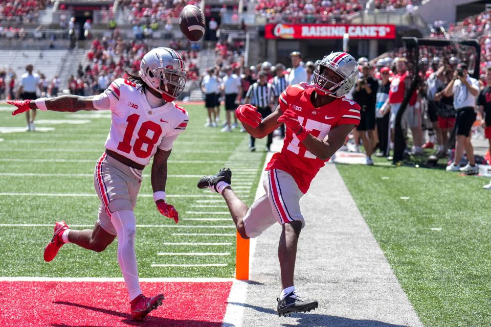 Apr 15, 2023; Columbus, Ohio, United States;  Ohio State Buckeyes wide receiver Carnell Tate (17) fights Ohio State Buckeyes cornerback Jyaire Brown (18) for a catch during the second quarter of the Ohio State Buckeyes spring game at Ohio Stadium on Saturday morning. Mandatory Credit: Joseph Scheller-The Columbus Dispatch