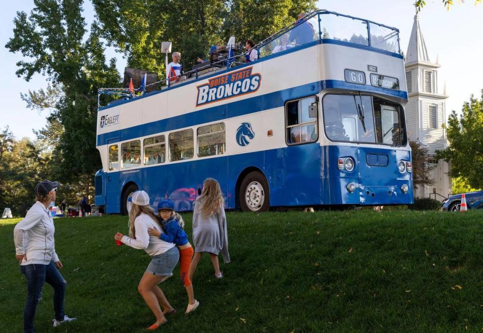 Boise State fans tailgate in style aboard a double-decker bus Saturday morning.