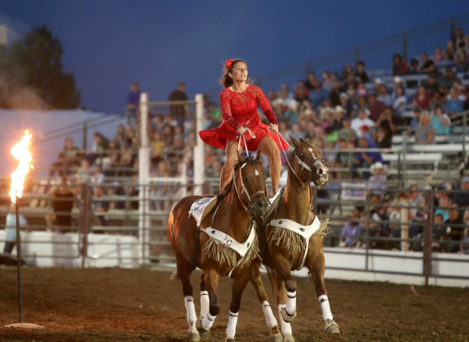 Trick rider Haley Ganzel rides two horses through obstacles of fire during Monday's portion of the Dacotah Stampede at the Brown County Fair. American News photo by Jenna Ortiz, 08/16/21.