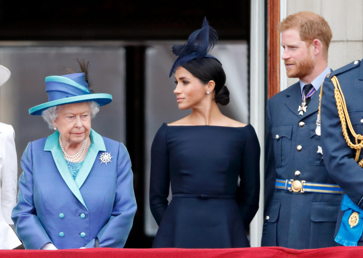 LONDON, UNITED KINGDOM - JULY 10: (EMBARGOED FOR PUBLICATION IN UK NEWSPAPERS UNTIL 24 HOURS AFTER CREATE DATE AND TIME) Queen Elizabeth II, Meghan, Duchess of Sussex and Prince Harry, Duke of Sussex watch a flypast to mark the centenary of the Royal Air Force from the balcony of Buckingham Palace on July 10, 2018 in London, England. The 100th birthday of the RAF, which was founded on on 1 April 1918, was marked with a centenary parade with the presentation of a new Queen's Colour and flypast of 100 aircraft over Buckingham Palace. (Photo by Max Mumby/Indigo/Getty Images)