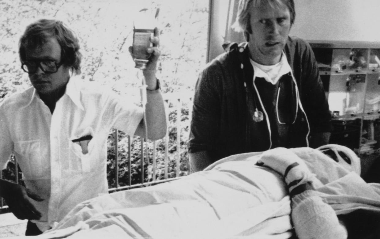Niki Lauda is carried into hospital at Ludwigshaven after suffering serious burns when his Ferrari caught fire during the German Grand Prix at Nurburgring in 1976