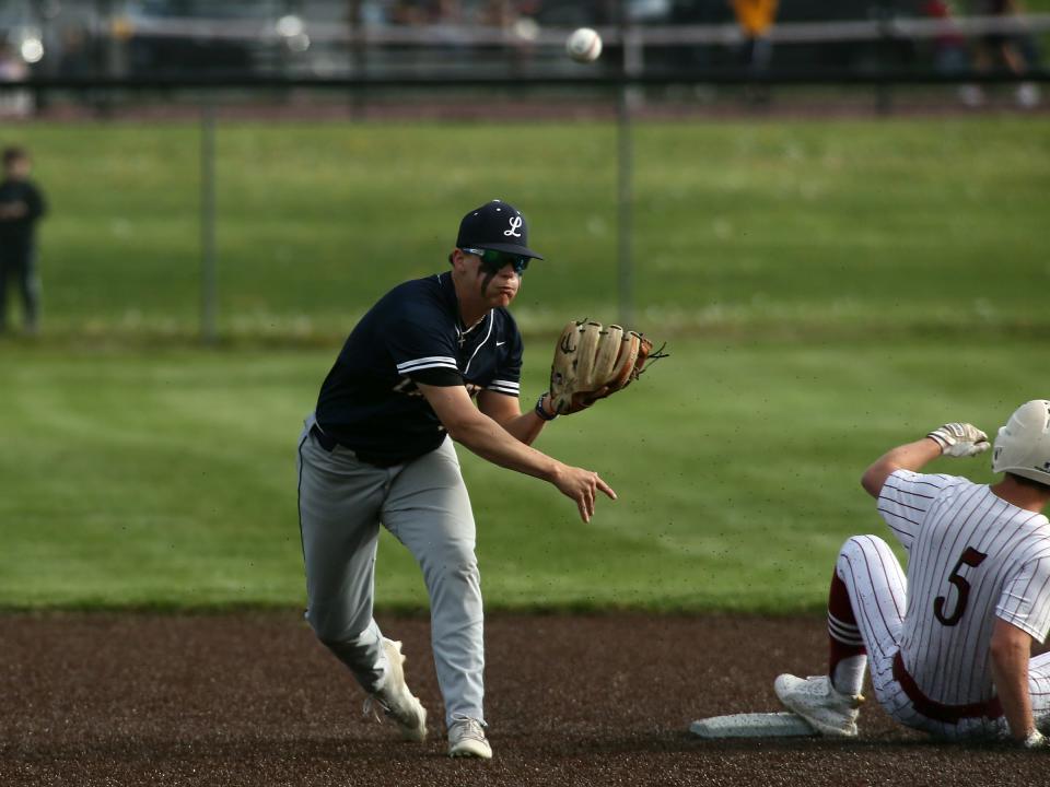 Lancaster's Kathen Hutton turns a double play after forcing Newark's Aidan Hamilton out at second during the visiting Golden Gales' 2-0 victory at Joe Neff Field.