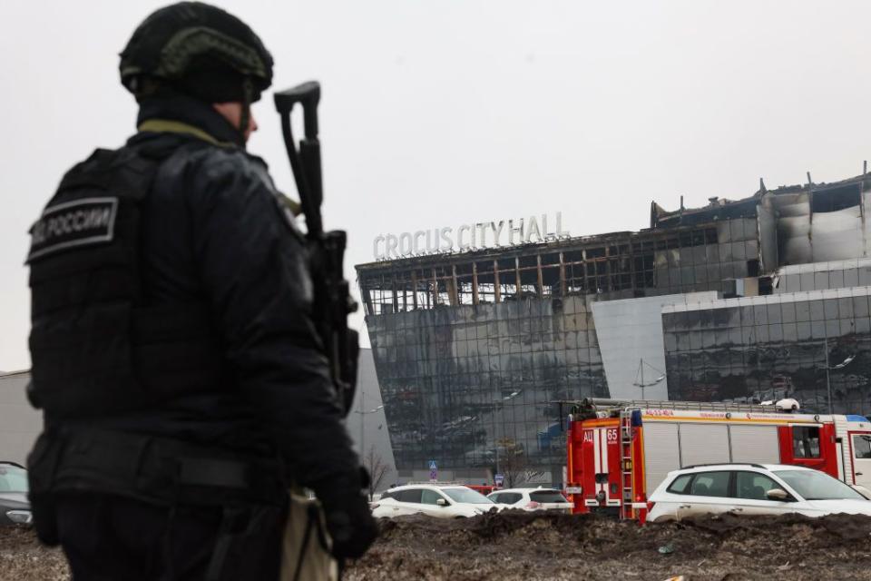 A Russian law enforcement officer patrols near the Crocus City Hall concert hall outside Moscow, Russia, on March 23, 2024, after the terrorist attack that killed at least 139 people. (Stringer/AFP via Getty Images)