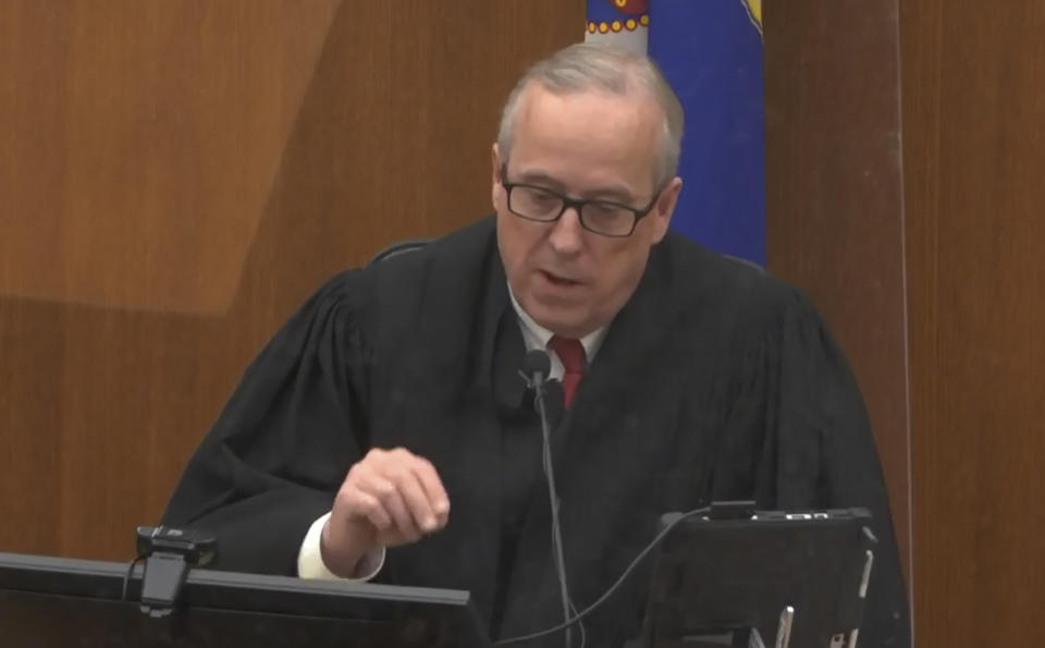 In this screen grab from video, Hennepin County Judge Peter Cahill presides over jury selection, Wednesday, March 17, 2021, in the trial of former Minneapolis police officer Derek Chauvin, in the May 25, 2020, death of George Floyd at the Hennepin County Courthouse in Minneapolis, Minn. The Judge dismissed a juror seated for ex-officer's trial who said $27M settlement to Floyd family would skew judgment. (Court TV, via AP, Pool)