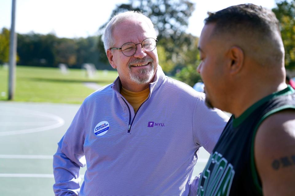 James L. Lathrop, Republican candidate for general treasurer,  chats with Luis Ortiz on the basketball court at Wilson Park in Wickford on Sunday.