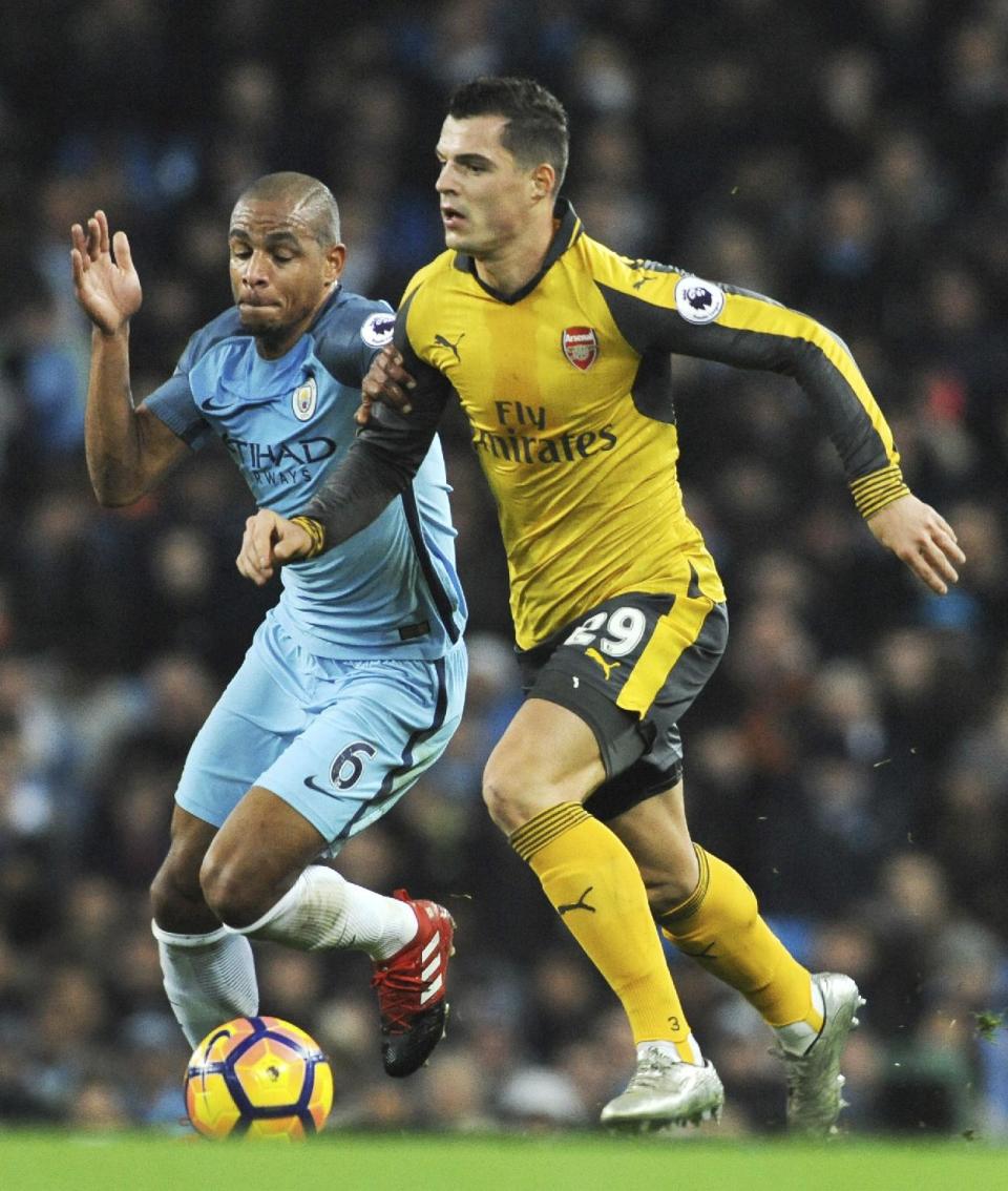 <p>Manchester City’s Fernando and Arsenal’s Granit Xhaka, right, in action during the English Premier League soccer match between Manchester City and Arsenal at the Etihad Stadium in Manchester, England, Sunday, Dec. 18, 2016. (AP Photo/Rui Vieira) </p>