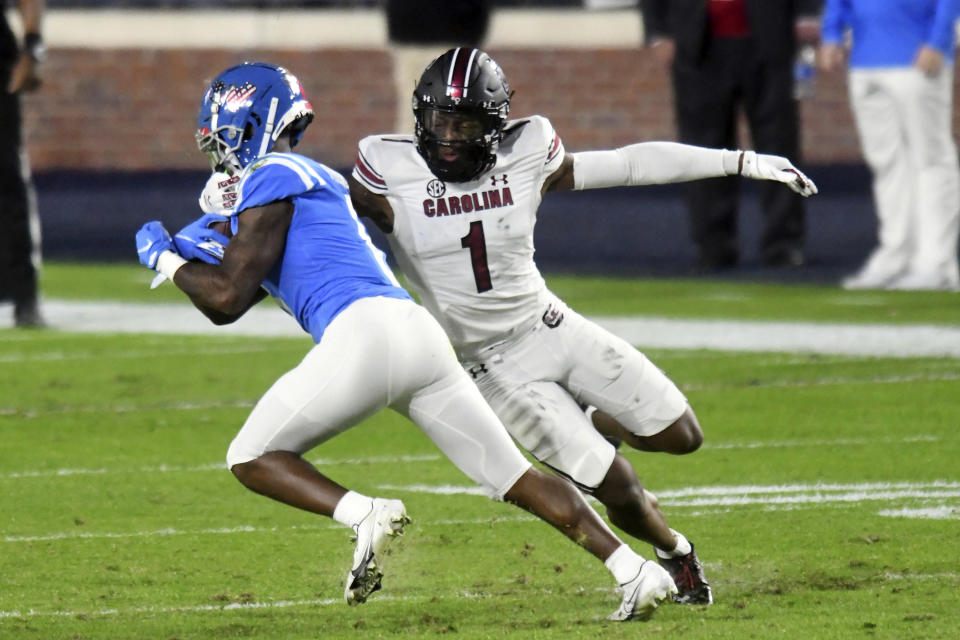 FILE - Mississippi wide receiver Elijah Moore is tackled by South Carolina defensive back Jaycee Horn (1) during the first half of an NCAA college football game in Oxford, Miss., Saturday, Nov. 14, 2020. Horn is a likely first round pick in the NFL Draft, April 29-May 1, 2021, in Cleveland.(AP Photo/Bruce Newman, File)