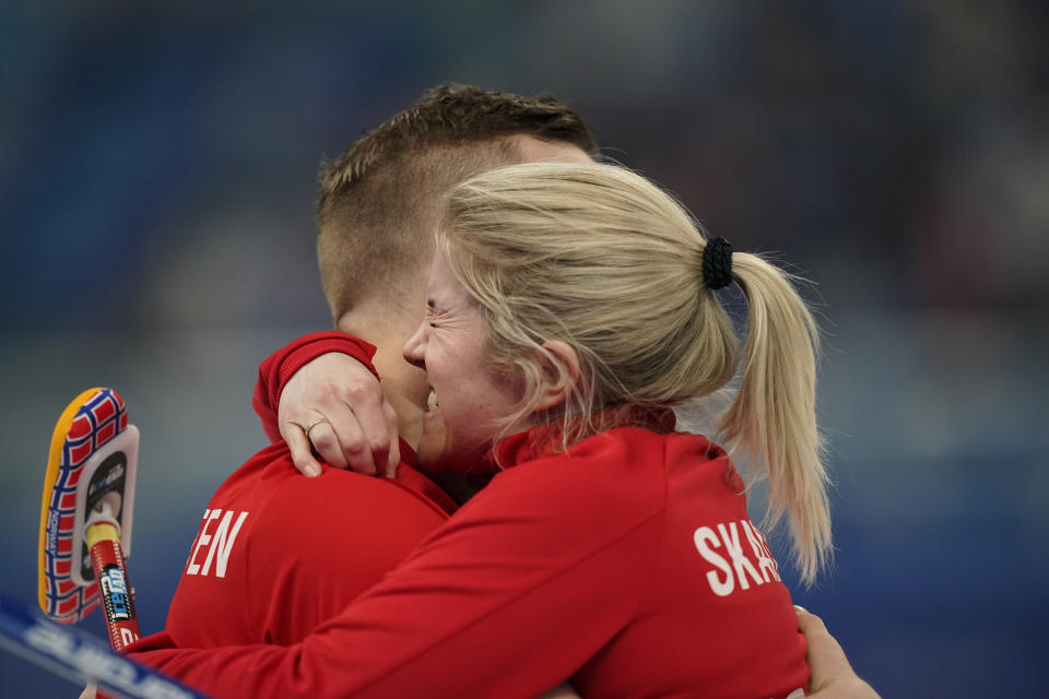 Kristin Skaslien, of Norway, celebrates with teammate Magnus Nedregotten, after a win against Britain during the semi-finals round of the mixed doubles curling match against at the Beijing Winter Olympics Monday, Feb. 7, 2022, in Beijing. (AP Photo/Brynn Anderson)
