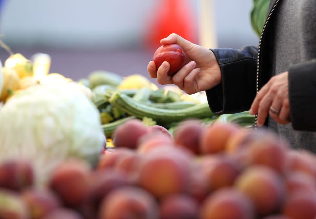 A person picks up produce