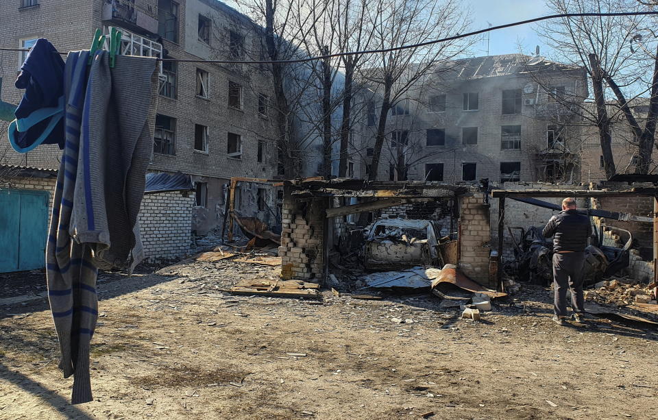 A man stands next to cars destroyed by a shelling, as Russia's attack on Ukraine continues, in Rubizhne, the Luhansk region, Ukraine March 24, 2022. Picture taken March 24, 2022. REUTERS/Stringer