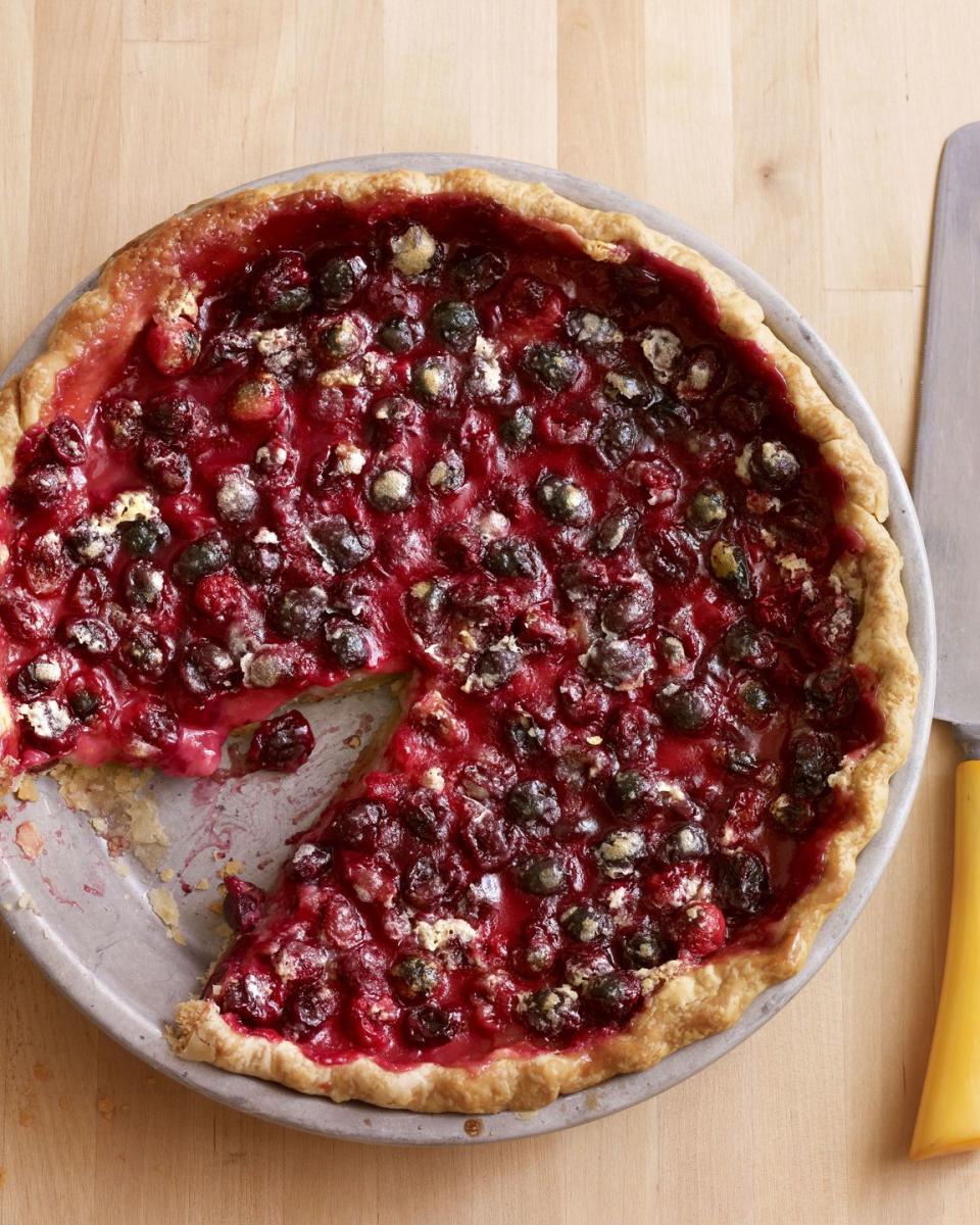 cranberry pie in a metal pie plate with a slice removed