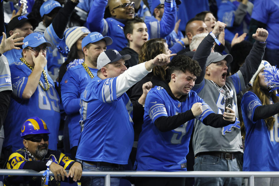 Detroit Lions fans cheer as the team defeats the Los Angeles Ramsduring the second half of an NFL wild-card playoff football game, Sunday, Jan. 14, 2024, in Detroit. (AP Photo/Duane Burleson)