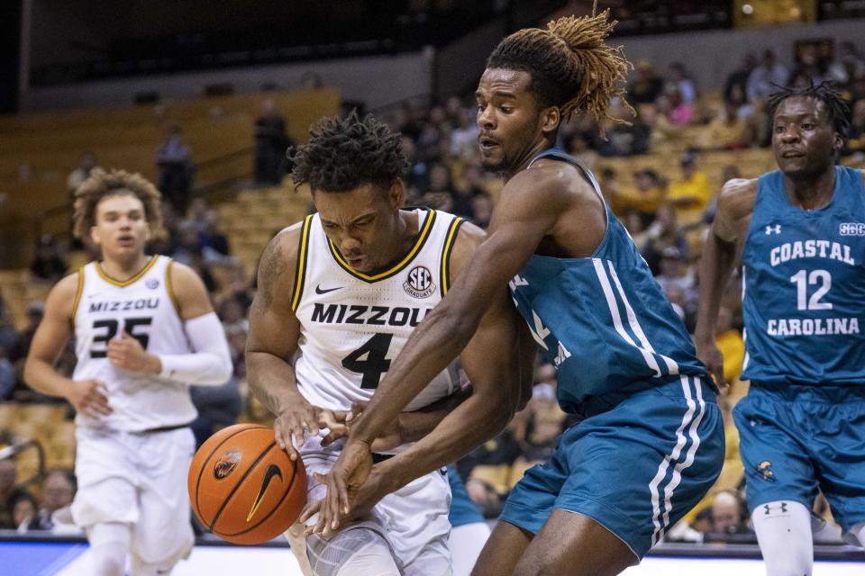 Coastal Carolina's Josh Uduje, right, knocks the ball away from Missouri's DeAndre Gholston, left, during the second half of an NCAA college basketball game Wednesday, Nov. 23, 2022, in Columbia, Mo. Missouri won 89-51.(AP Photo/L.G. Patterson)