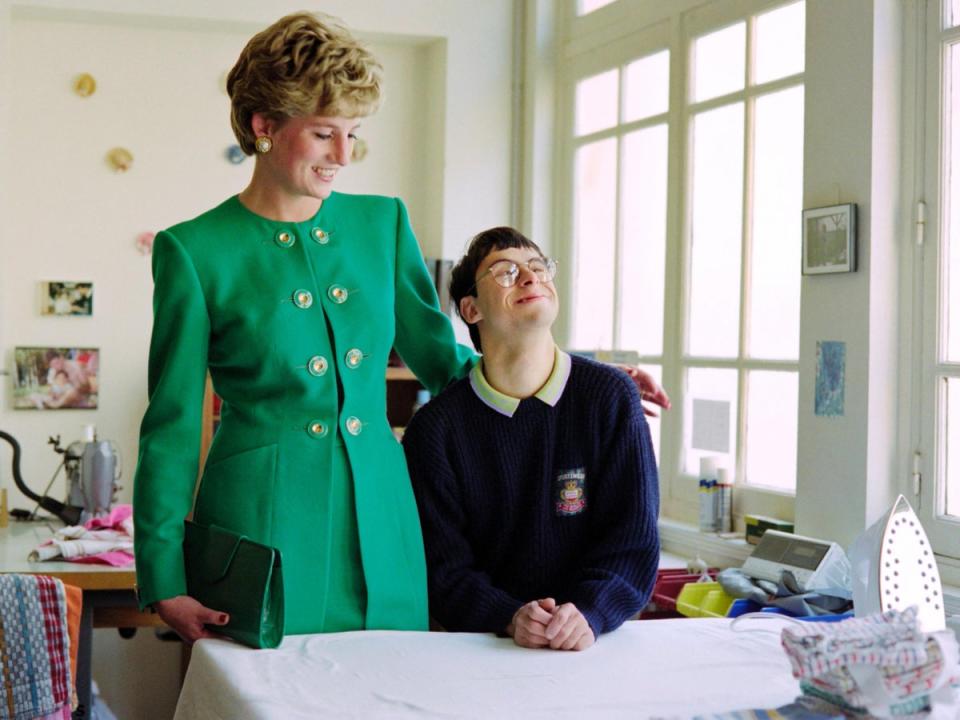 Diana listens to a young boy with learning difficulties on 13 November, 1992 during her visit to a school in Paris (Joel Robine/AFP)