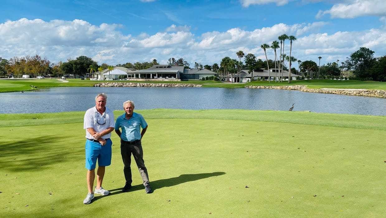 The Yards owner David Miller (left) and general manager Mike Miles stand on one of the greens that will make up part of a six-hole par-3 course, with the clubhouse in the background.