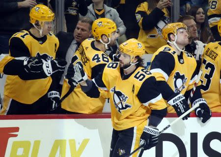 Feb 17, 2019; Pittsburgh, PA, USA; Pittsburgh Penguins defenseman Kris Letang (58) celebrates with teammates on the bench after scoring a goal against the New York Rangers during the third period at PPG PAINTS Arena. Mandatory Credit: Charles LeClaire-USA TODAY Sports