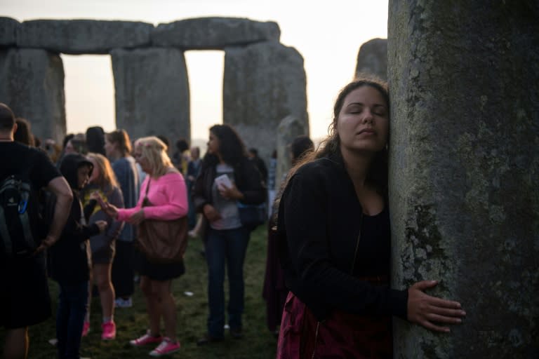 Revellers hug the famous stones of Stonehenge as the summer solstice arrives