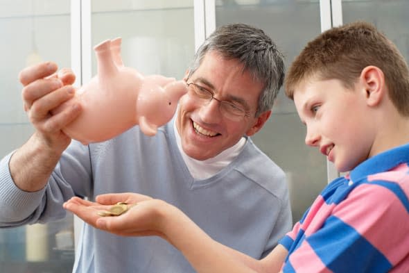 Father and Son With Piggy Bank